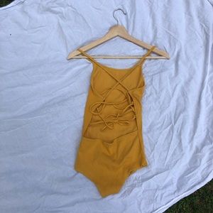 NWOT Yellow bodysuit crossed in the back